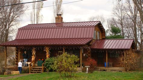 red house with brown metal roof|rustic red metal siding.